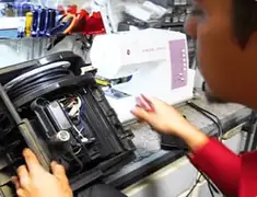 Vacuum repair technician servicing internal components on a workbench in Aurora, CO