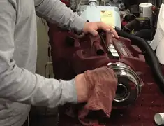 Vacuum repair technician cleaning and servicing a vacuum motor in Aurora, CO